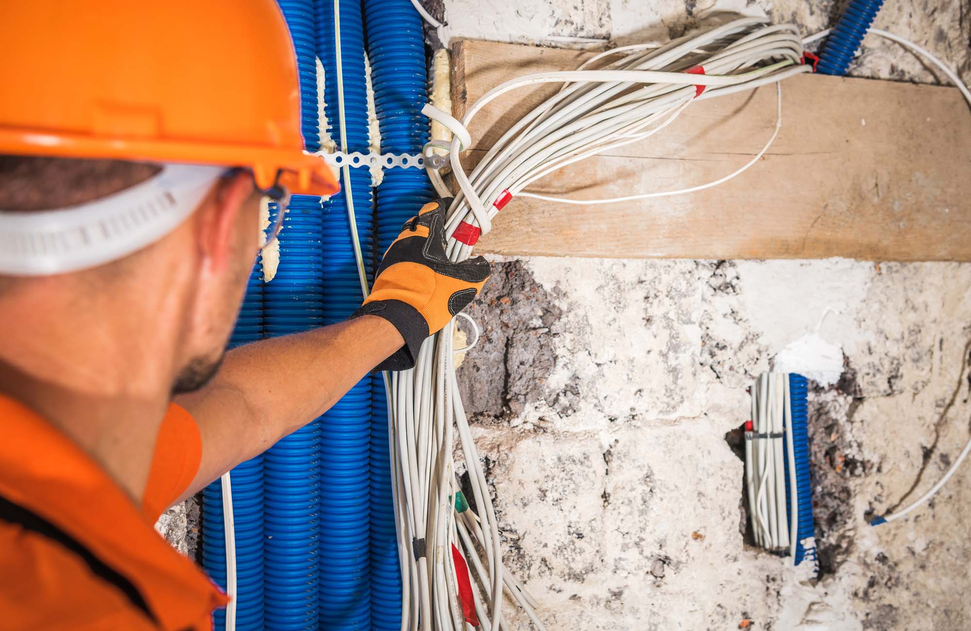 Electrical contractors fixing wires in a large comercial building